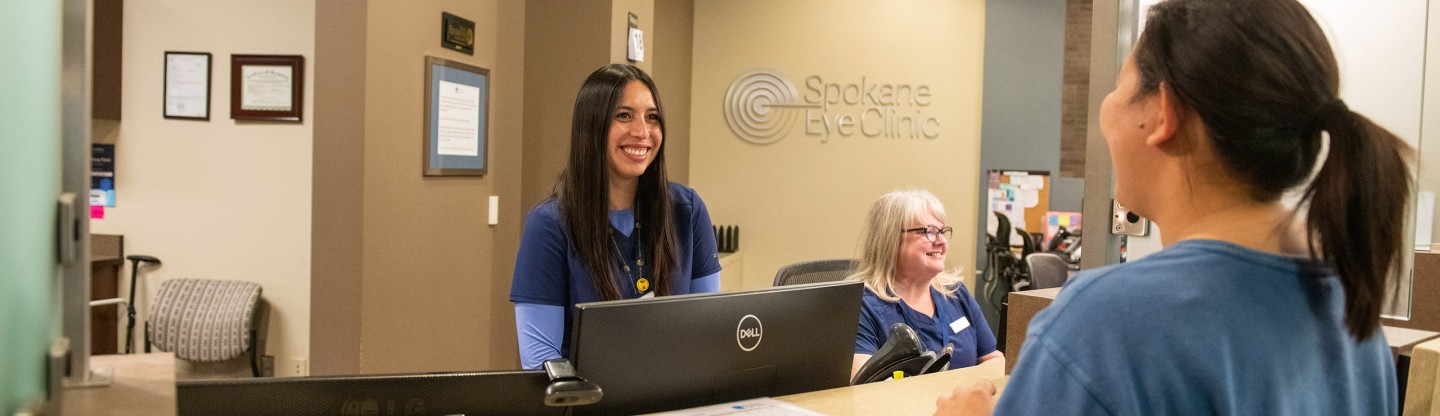 a female receptionist talking to a female patient spokane eye clinic