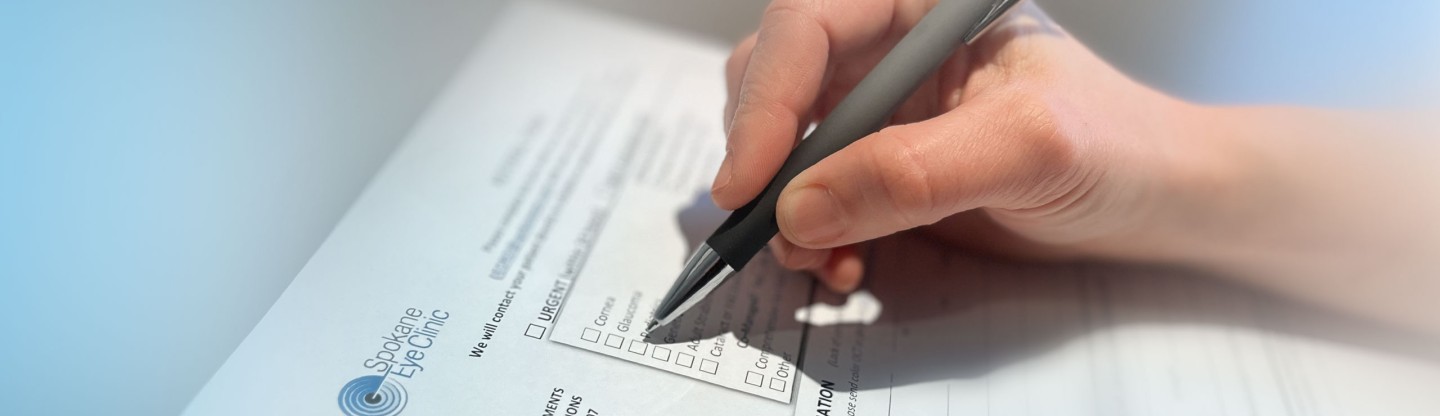 a person filling out a referral form spokane eye clinic v2