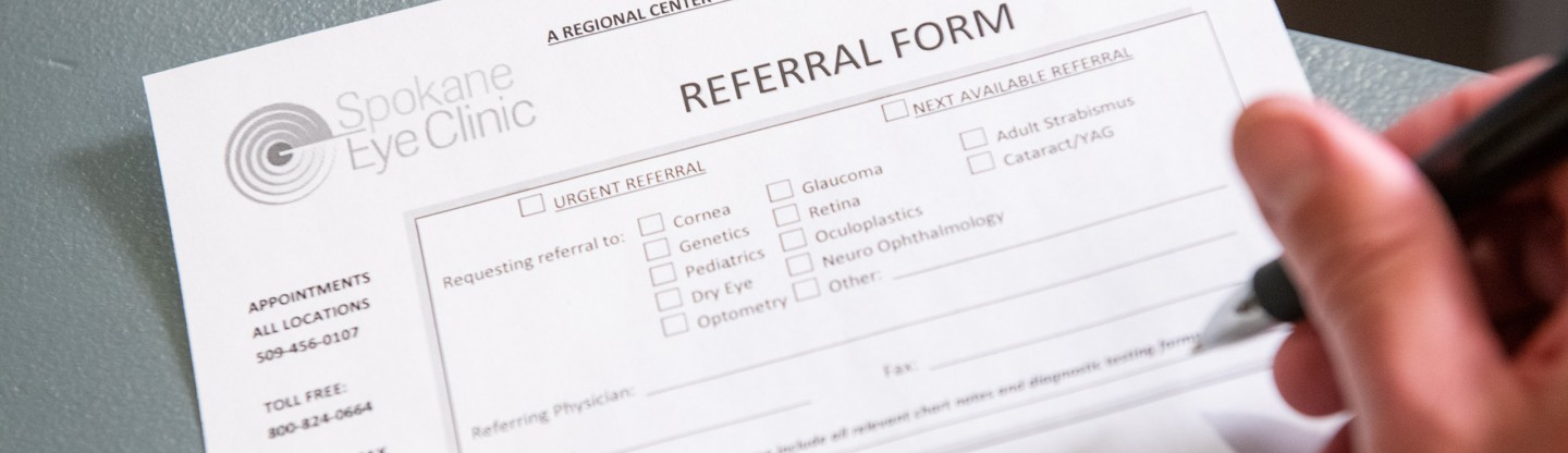 a person filling out a referral form spokane eye clinic